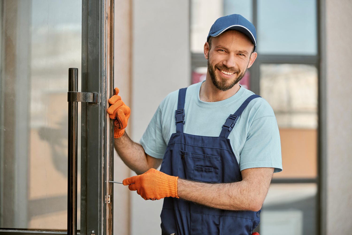 A contractor repairing a door on the job